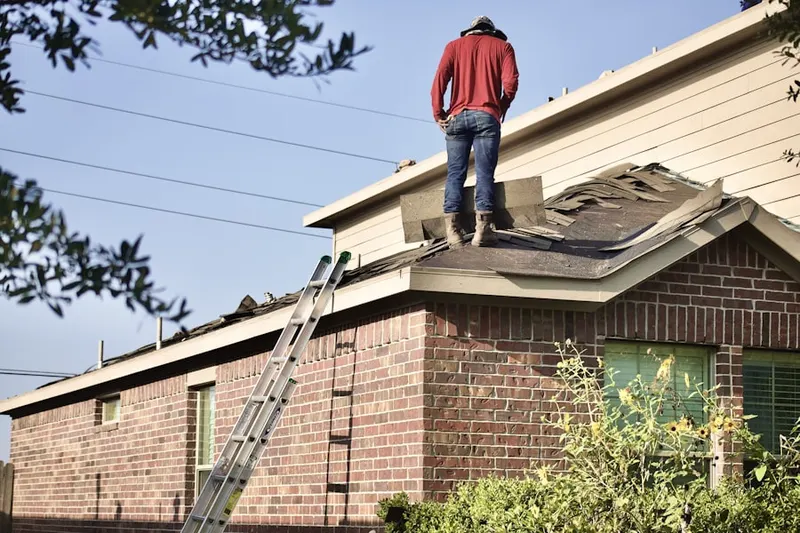 Professional roofer working on a residential roof in Rummel